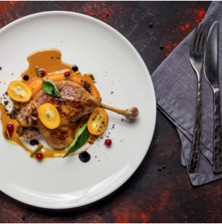 Confit of duck with reduced orange duck jus, pomme grenade and sweet potatoes and carrots mash